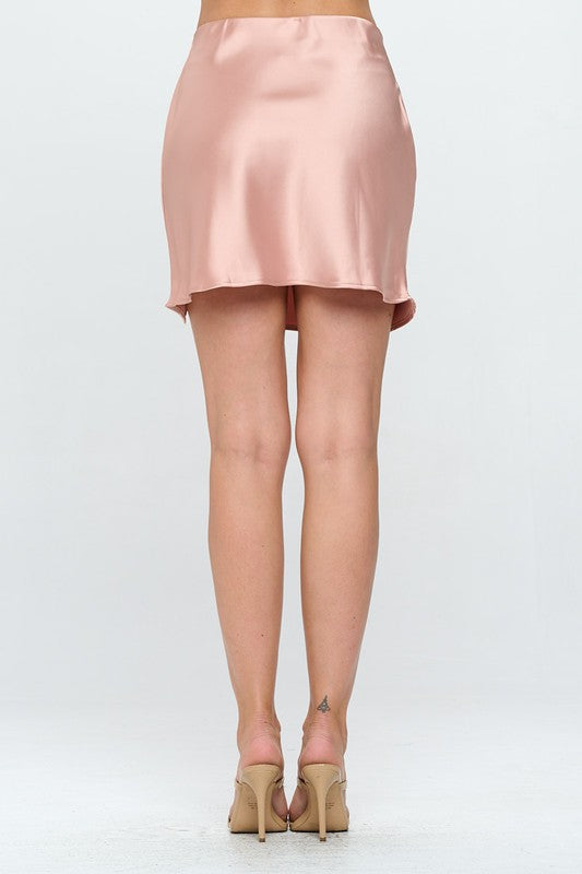 Automotive Jade Icarus solid satin mini skirt with slit, featuring a smooth, shiny fabric and stylish slit detail.
