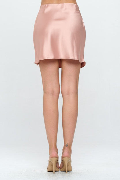 Automotive Jade Icarus solid satin mini skirt with slit, featuring a smooth, shiny fabric and stylish slit detail.