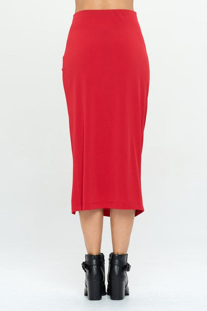 Made in USA Jade Icarus midi skirt with front knot and slit, shown on a model in a stylish indoor setting.
