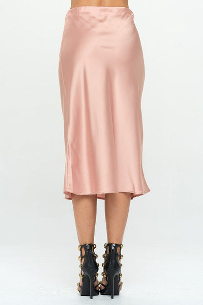 Jade Icarus Made in USA solid stretch satin midi skirt showing smooth fabric and fitted waist on a model.