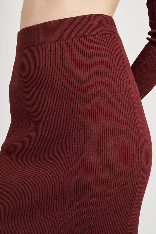 Jade Icarus high waist midi pencil skirt for women, fitted silhouette, beige fabric, styled with a tucked-in blouse.