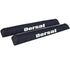 Cyan Hecuba DORSAL Aero Rack Pads on 34-inch car crossbar holding a surfboard and kayak for roof transport.