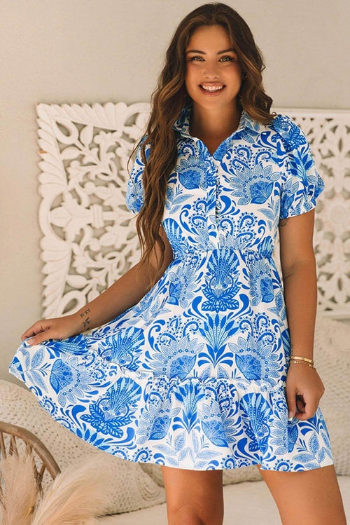 Sky blue retro floral print mini dress with drawstring waist and ruffled hem by Carmine Juneberry, perfect for summer.