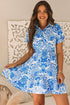 Sky blue retro floral print mini dress with drawstring waist and ruffled hem by Carmine Juneberry, perfect for summer.