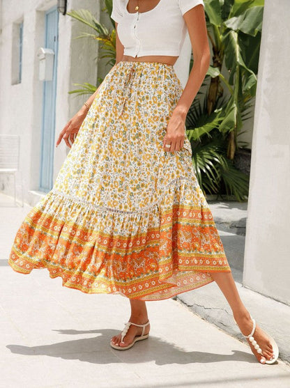 Floral midi skirt for women by Jade Icarus, featuring a flowing fabric with colorful flower patterns.