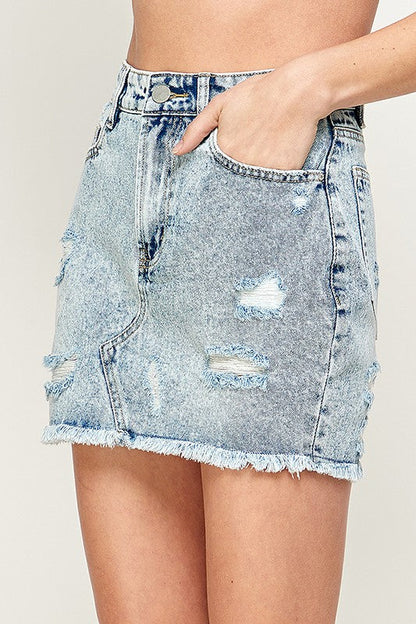 Women’s denim mini skirt by Jade Icarus, showing the fitted style and classic blue denim fabric with front pockets.