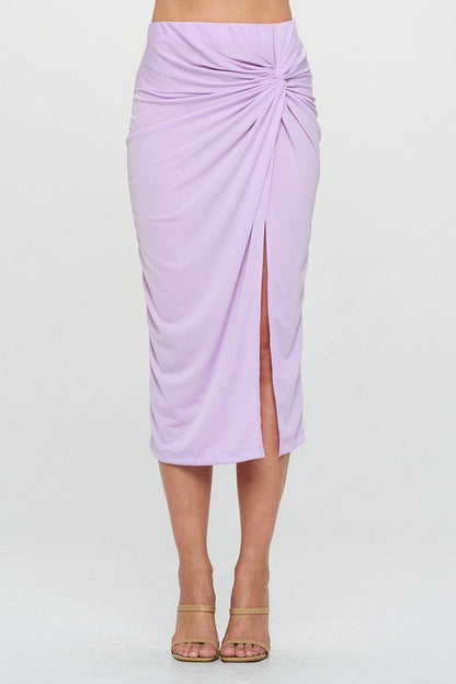 Jade Icarus made in USA midi skirt with front knot and slit, shown on a model with a casual outfit and neutral background.