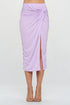 Jade Icarus made in USA midi skirt with front knot and slit, shown on a model with a casual outfit and neutral background.
