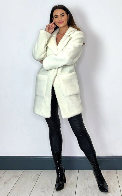 Cream Rose Eleusis Borg Teddy Coat with stud button details, showcasing a cozy, plush jacket for cold weather.