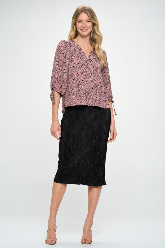 Made in USA Jade Icarus solid plisse midi skirt, showcasing its textured fabric and elegant length.