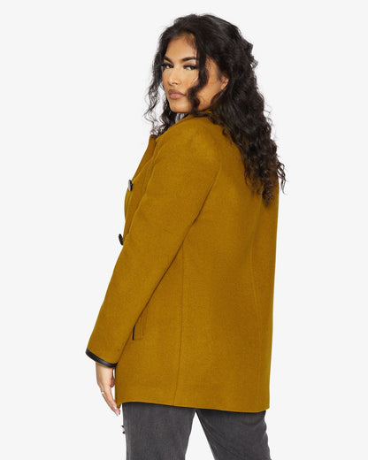 Rose Eleusis wool blend contrast trim coat from 1920s featuring tailored design and stylish color accents, shown on a model.