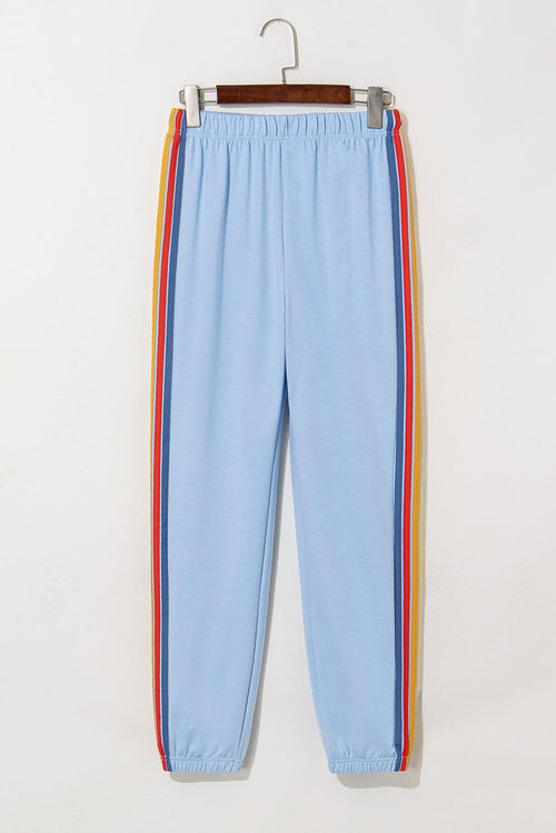 Light blue counting rainbows high waist sweatpants by Carmine Juneberry, showing the colorful rainbow print and comfortable fit.