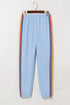 Light blue counting rainbows high waist sweatpants by Carmine Juneberry, showing the colorful rainbow print and comfortable fit.