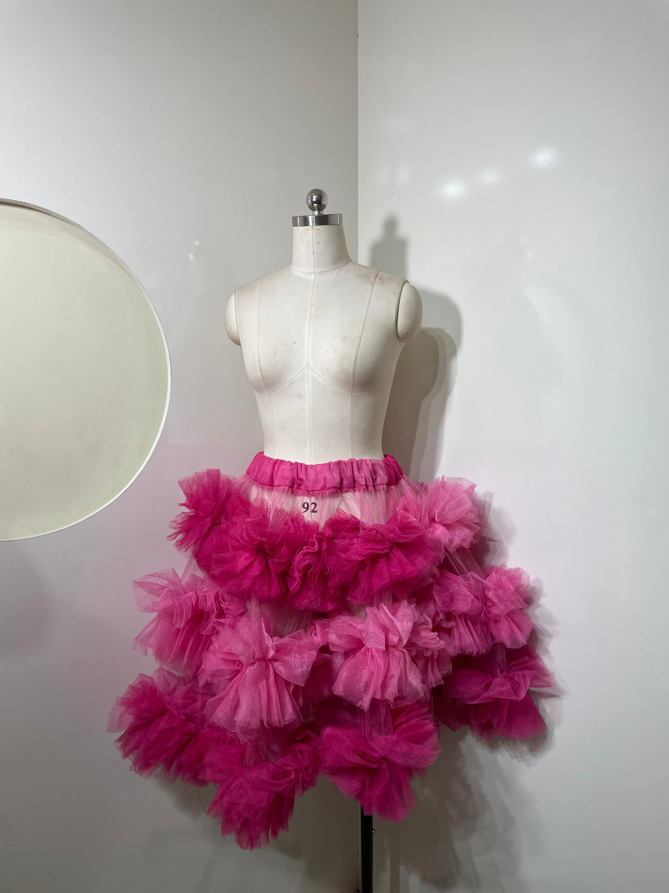 Pink tiered skirt for women by Champagne Pontus, featuring flowing fabric and layered design perfect for stylish outfits.