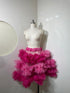 Pink tiered skirt for women by Champagne Pontus, featuring flowing fabric and layered design perfect for stylish outfits.
