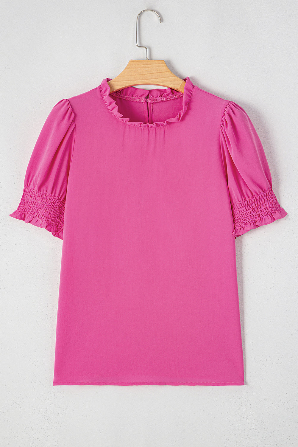Rose-colored solid smocked puff sleeve blouse by Carmine Juneberry, featuring a feminine neckline and lightweight fabric.