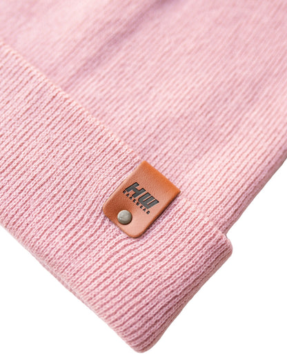 Azure Arrowwood HAAKWEAR Pearl Pink knit beanie with cuff, cozy winter hat made of soft, textured knit fabric.