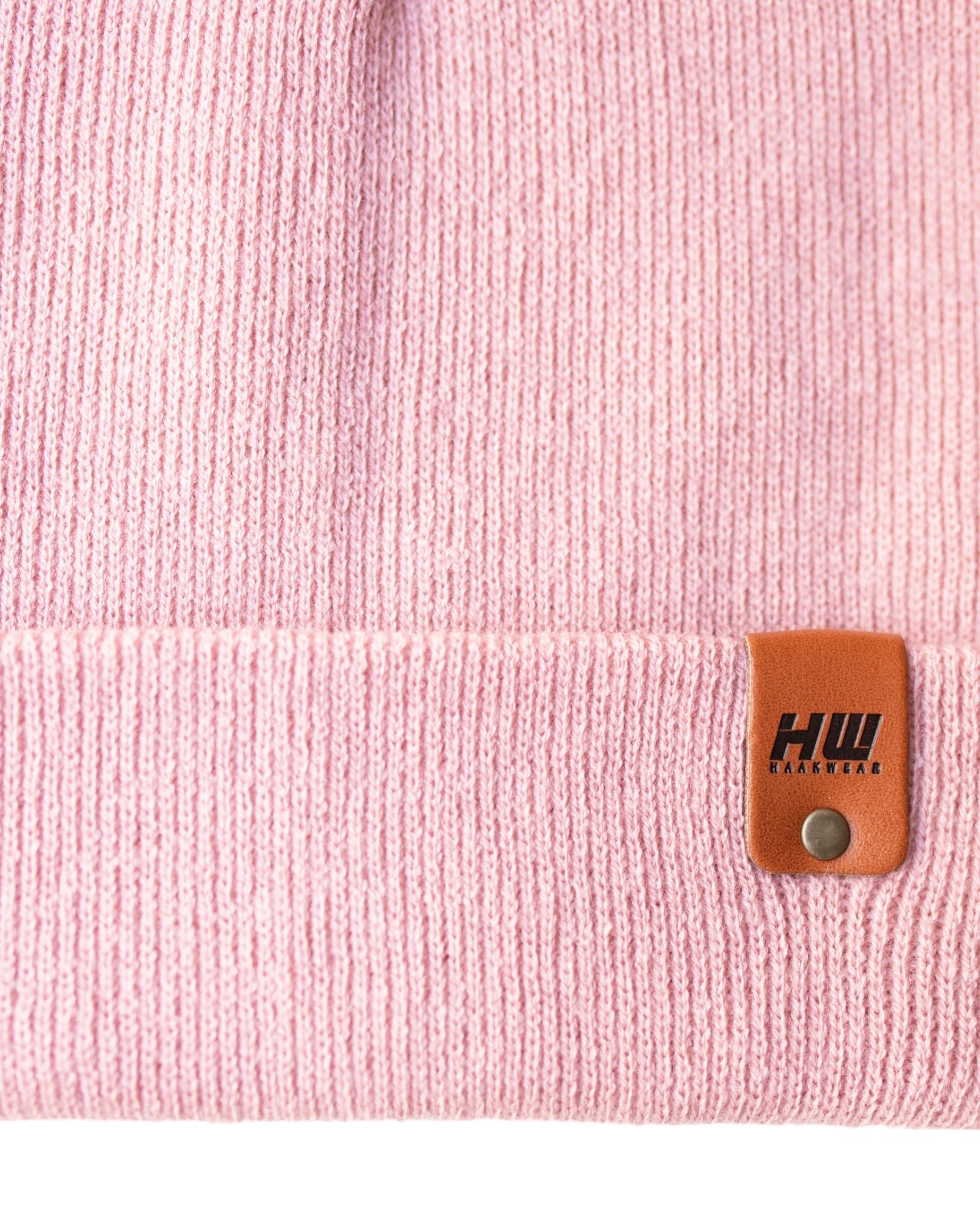 Azure Arrowwood HAAKWEAR knit cuffed beanie in pearl pink, featuring a cozy, stylish hat with a folded cuff and soft knit texture.