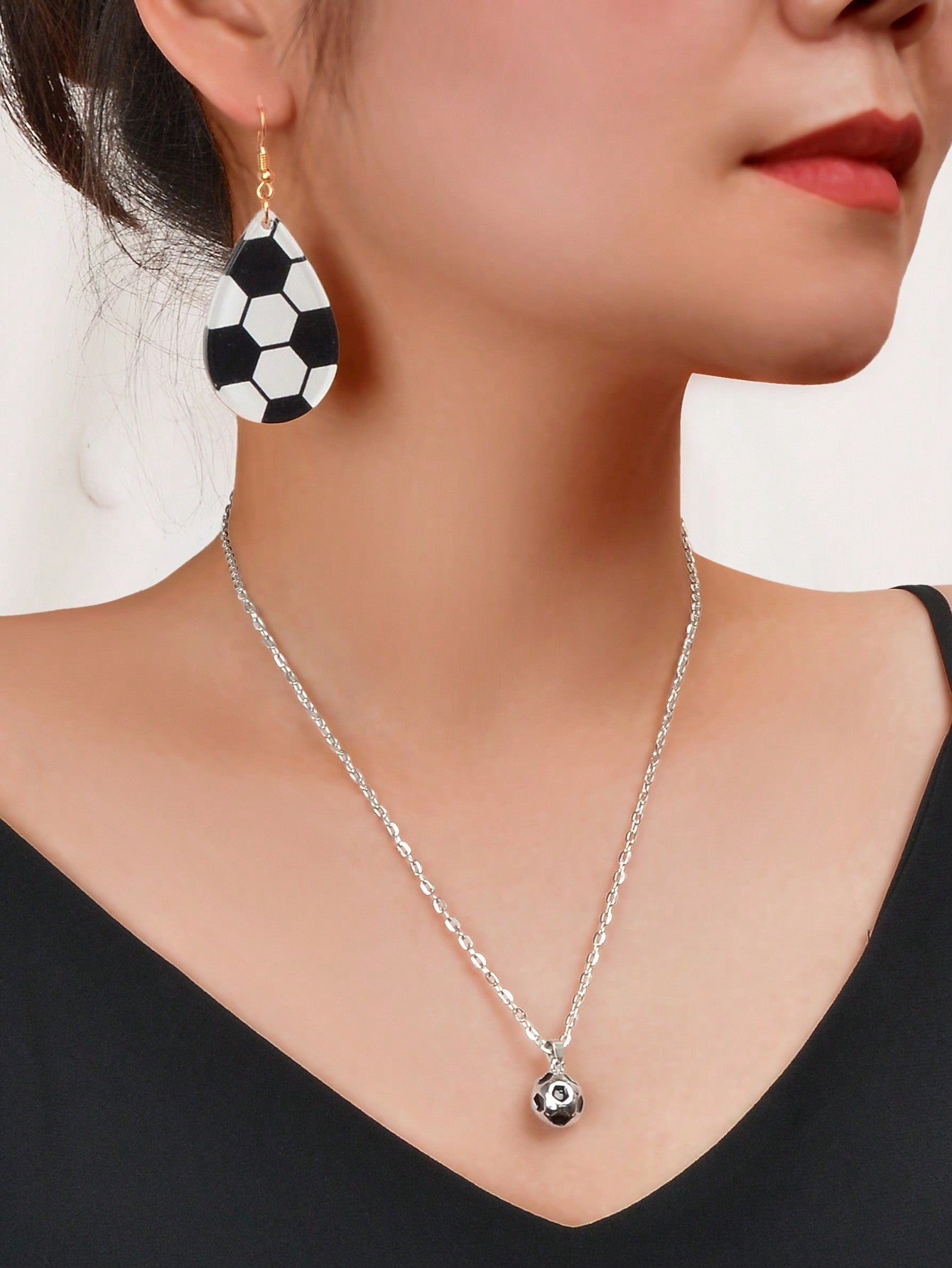 White Demeter sporty soccer pendant necklace and matching earrings set featuring soccer ball charms and stylish jewelry design.