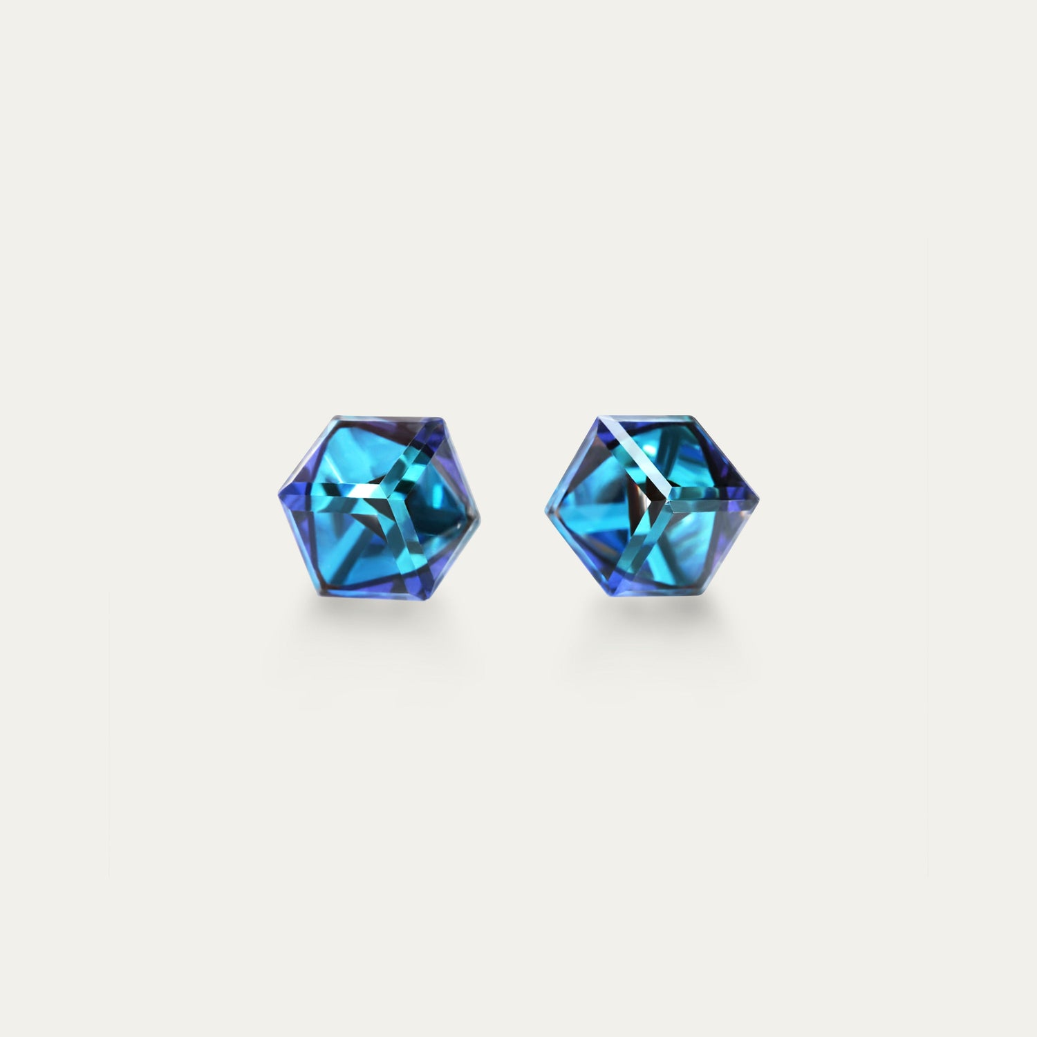 Cyan Apollo Irene Bermuda Blue earrings with 4mm iridescent and blue cubic crystal studs, showcasing vibrant color and sparkling detail.