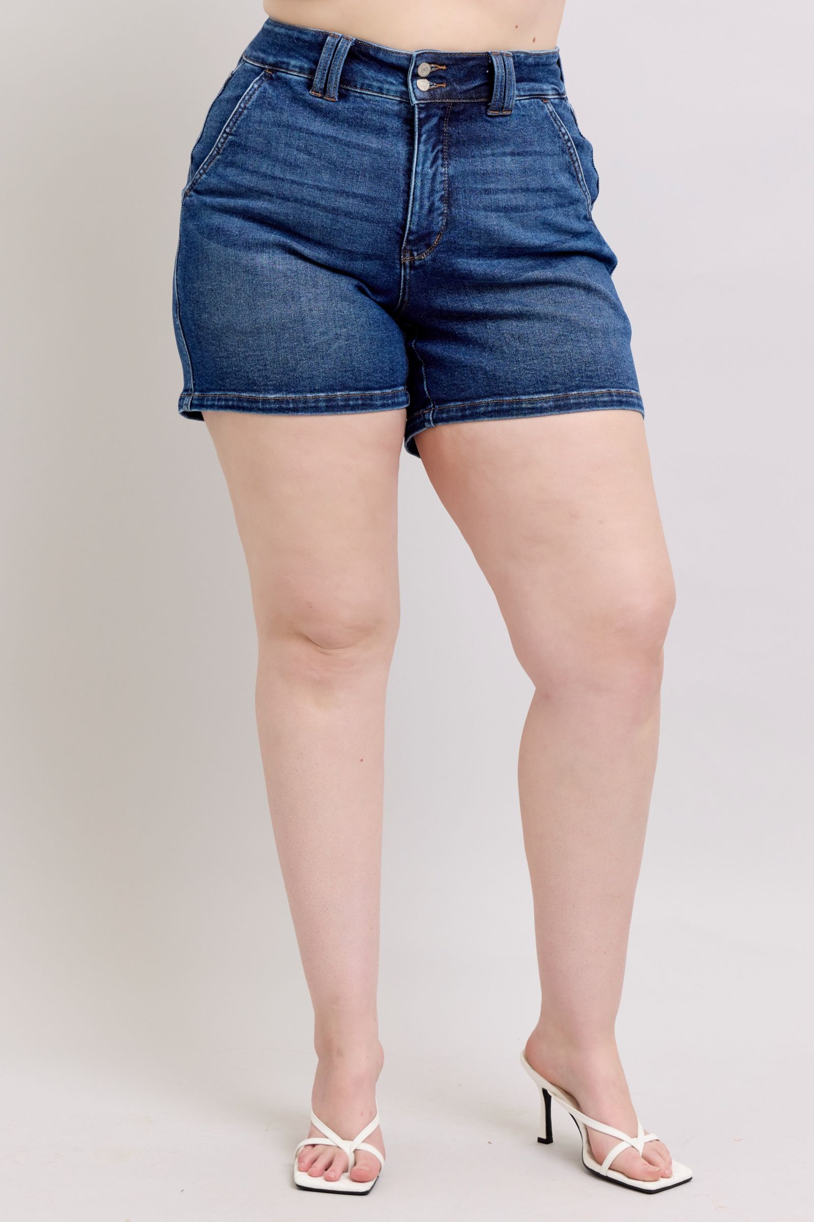 Judy Blue plus size double button denim shorts with waistband, featuring a classic blue wash and distressed details.