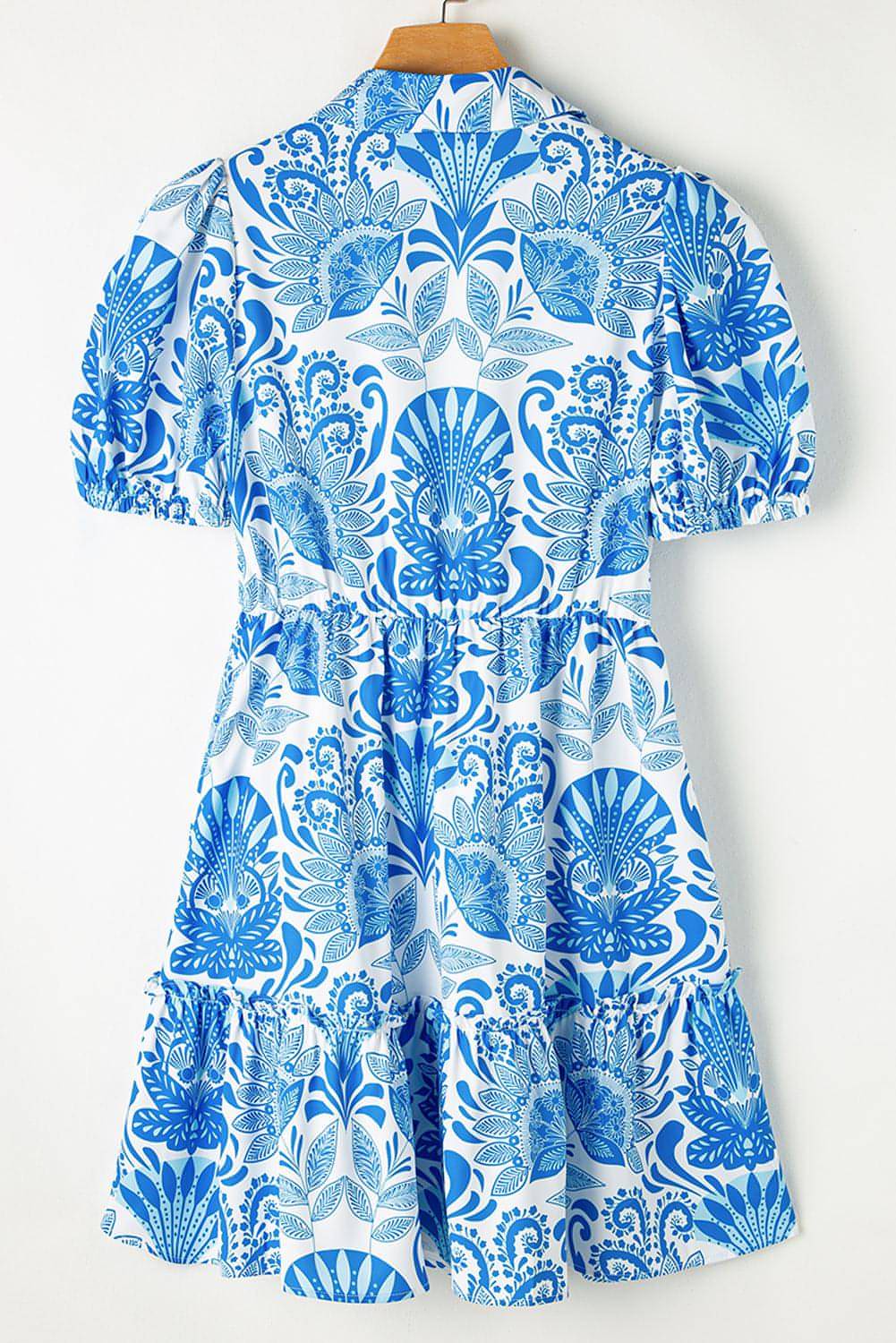 Sky blue retro floral print mini dress with drawstring waist and ruffled hem by Carmine Juneberry.