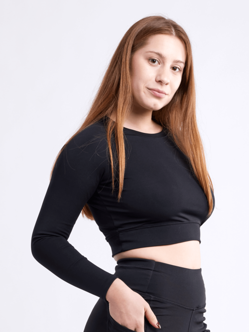 Black Lavender JupiterGear long-sleeve crop top for activewear, shown in black with fitted style and thumbholes on sleeves.