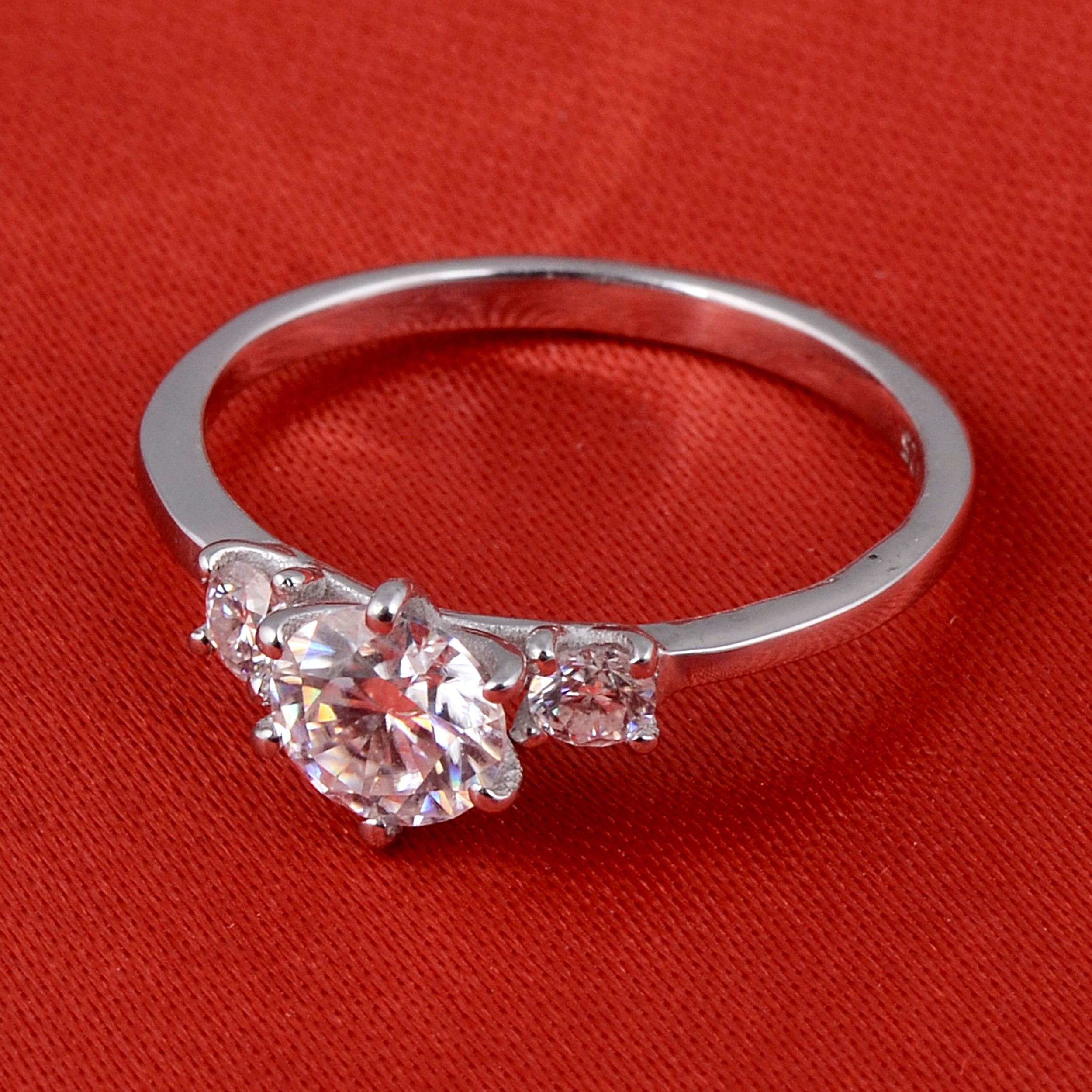 Sterling silver white moissanite 3-stone ring with elegant design, showcasing sparkling gemstones on a sleek band.