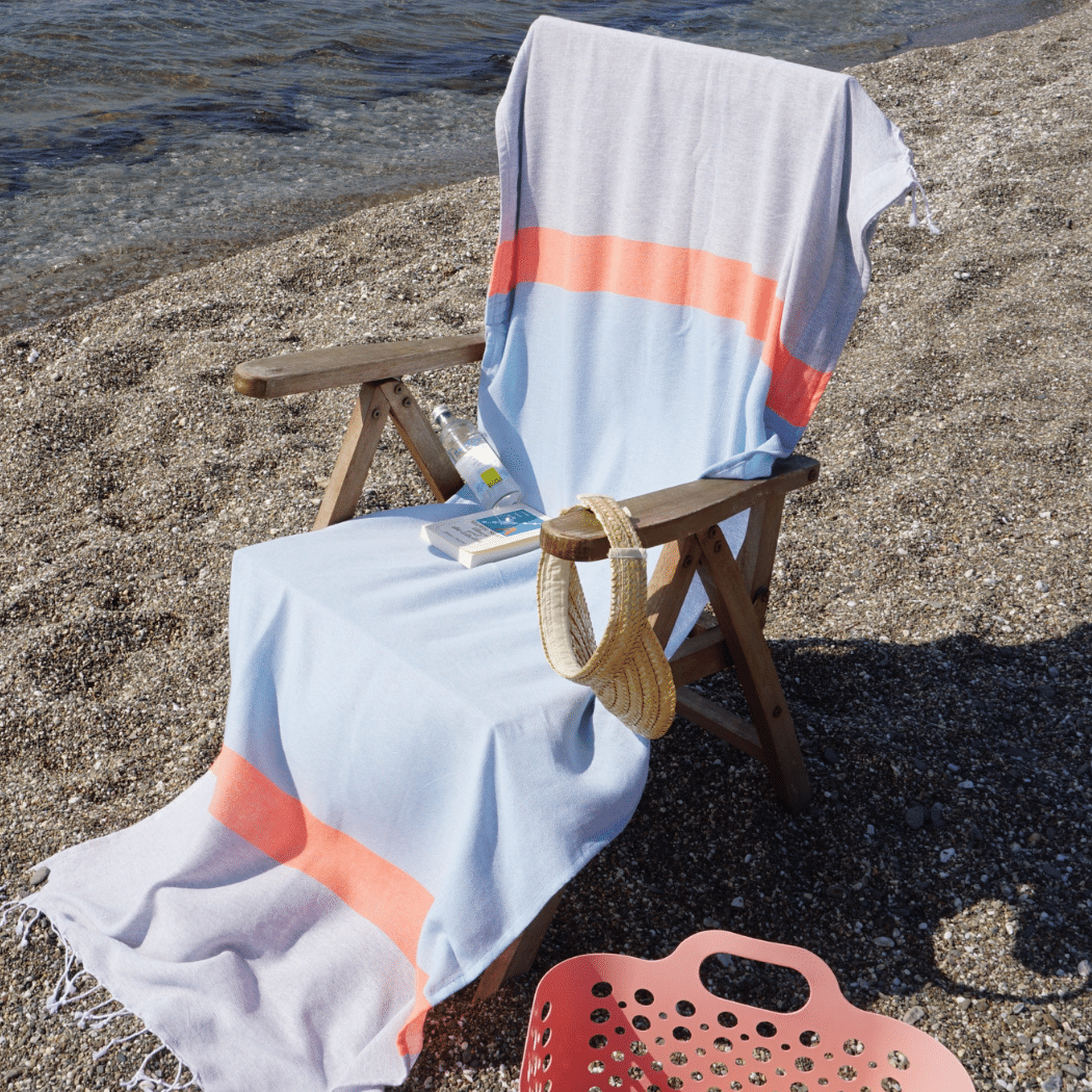 Neon mint and lime 2-in-1 Hammam towel and bag made from recycled cotton by Copper Amymone, showing the vibrant fabric and design.