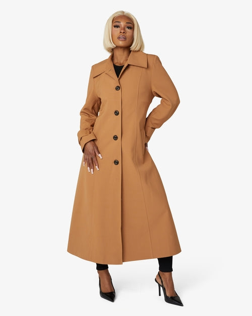 Longline spring/summer Mac coat by Rose Eleusis in toffee color, featuring lightweight fabric and classic coat design.