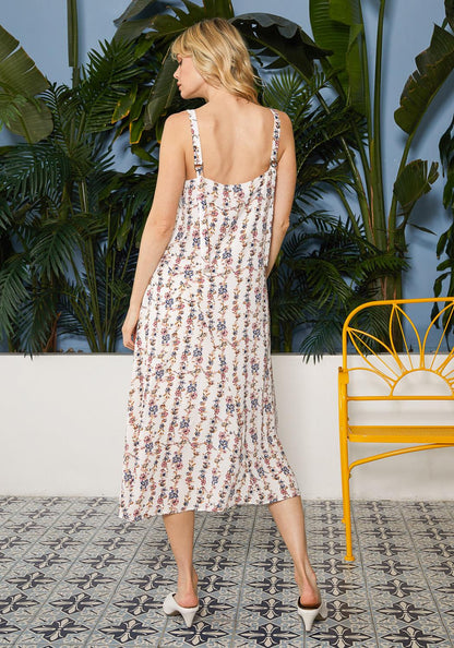 Floral V-neck sleeveless maxi dress by Lemon Hera with a flowing silhouette and vibrant floral pattern.