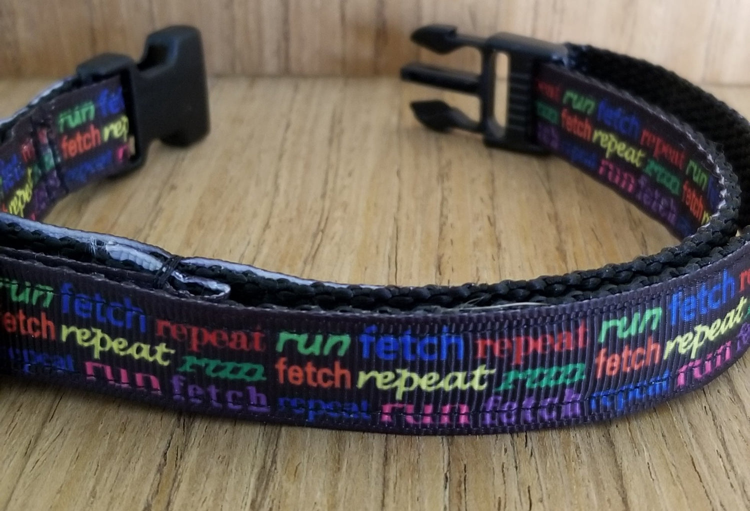 Small Green Thalassa collar with "Run Fetch Repeat" text, designed for pets, featuring a sturdy buckle and vibrant green color.