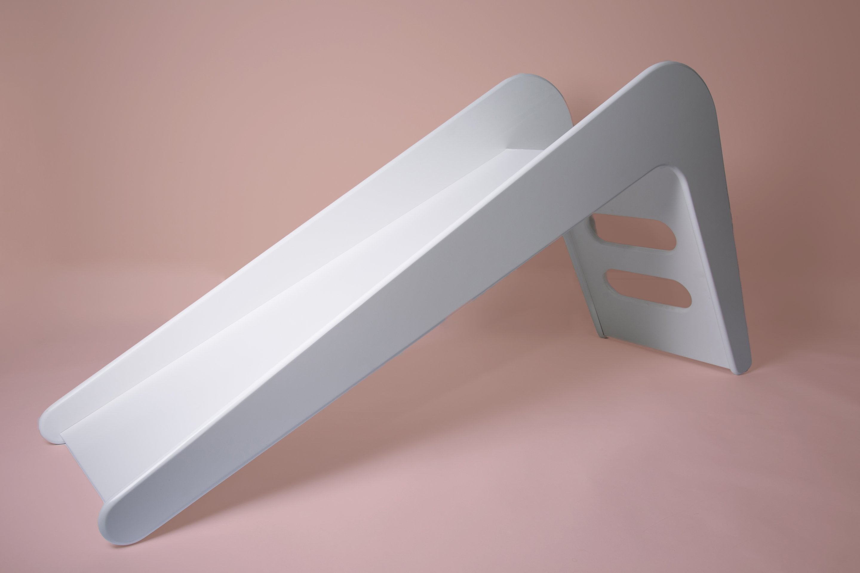 White wooden indoor slide for kids by Rose Metis, featuring a smooth, sturdy design perfect for playful indoor use.