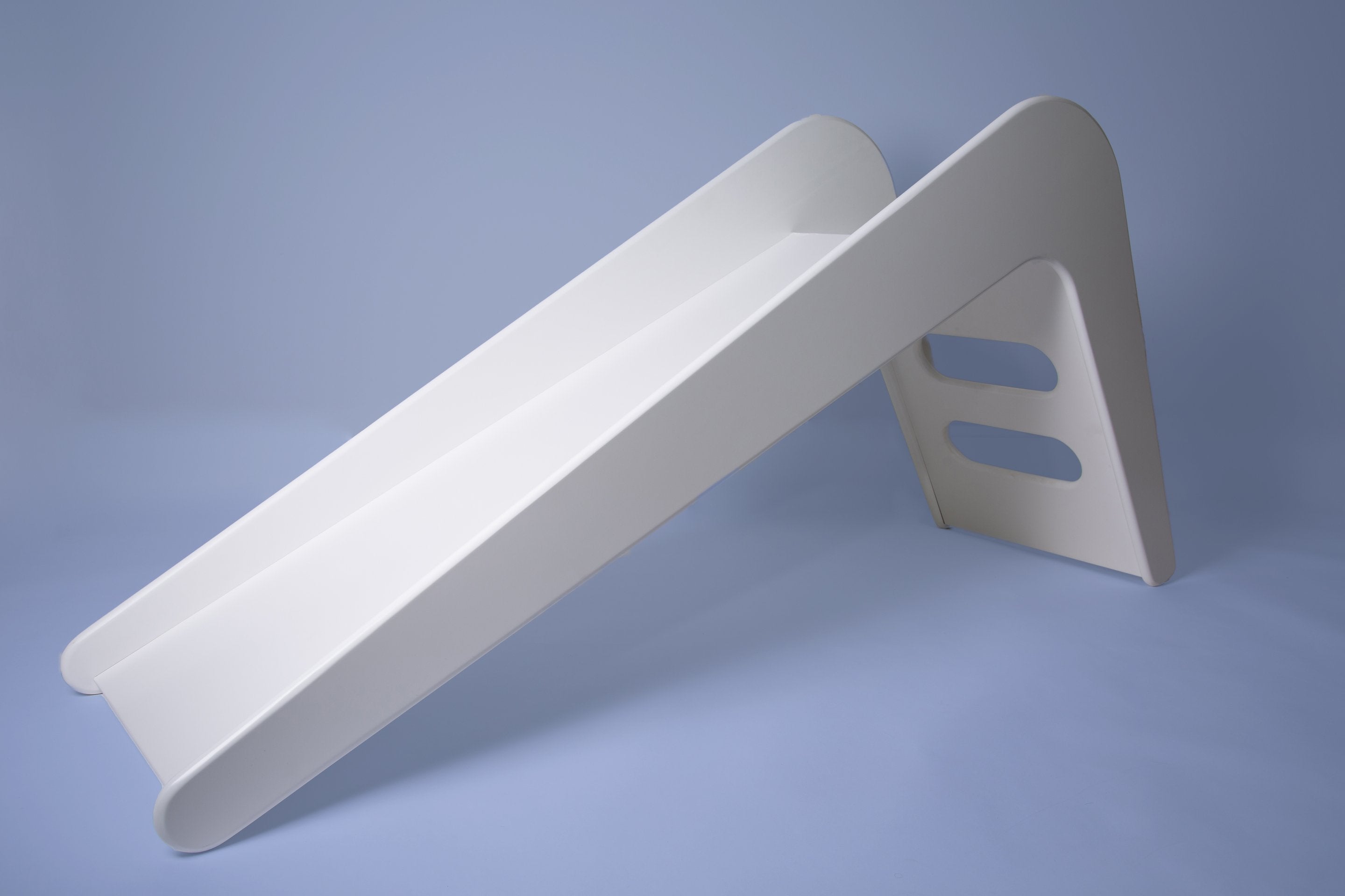 White wooden indoor slide for kids by Rose Metis, featuring a sleek design and smooth finish, ideal for playrooms.