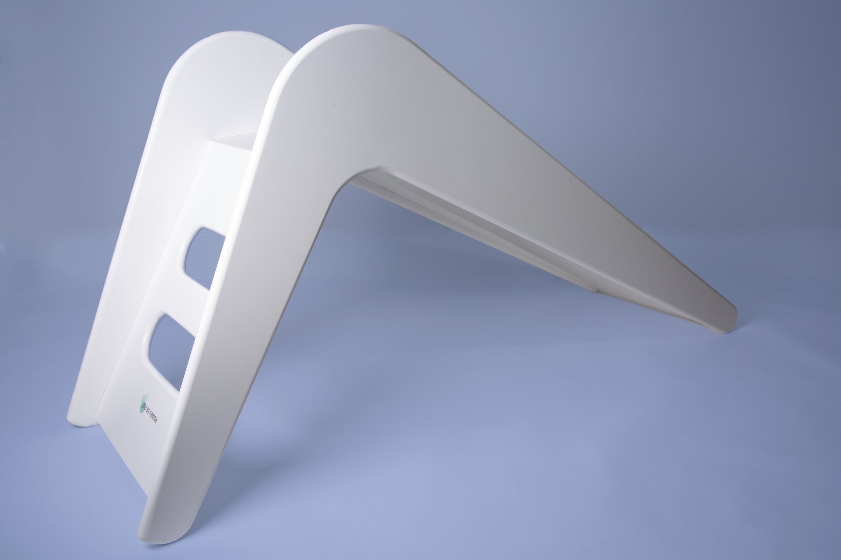 White wooden indoor slide for kids by Rose Metis, featuring a smooth, sturdy design perfect for indoor play areas.