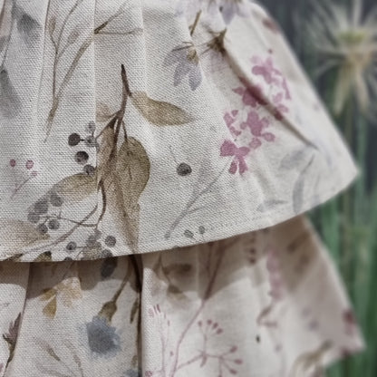 Kids’ linen-cotton apron with ruffles and printed design by Rose Trillium, featuring a charming, lightweight home decor style.