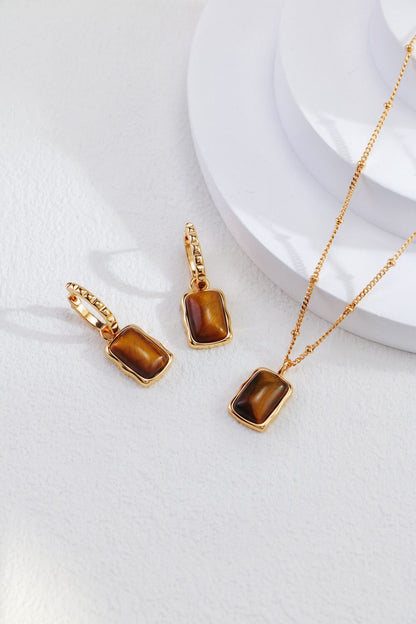 Rectangle-shaped tiger eye long earrings from Amethyst Arachne featuring polished gemstone drops and gold-tone hooks.