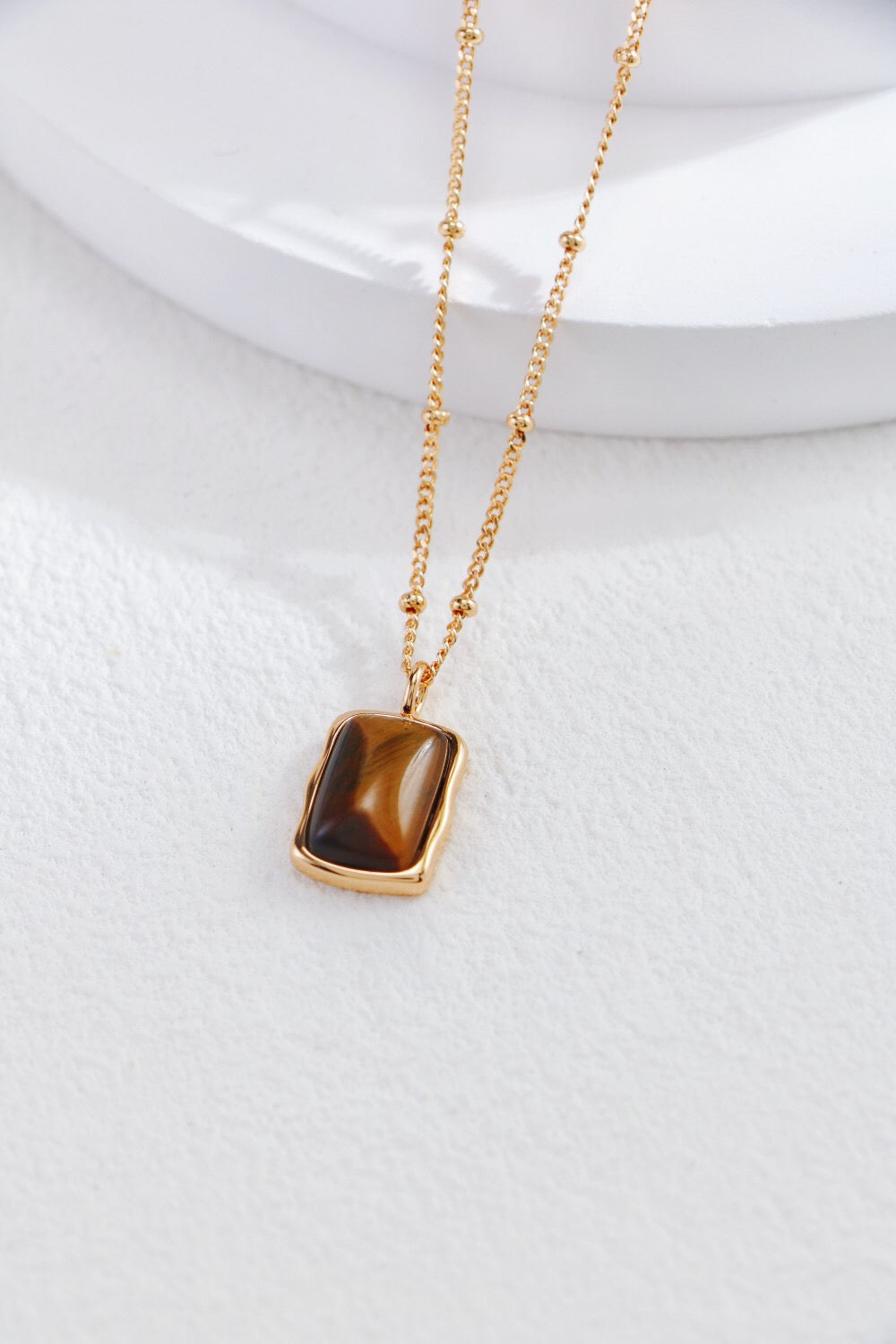 Rectangle-shaped tiger eye long earrings by Amethyst Arachne featuring polished gemstone drops and intricate metal hooks.