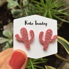 Pink cactus-shaped sparkly acrylic earrings by Olive Felix, featuring vibrant pink color and glittery surface.