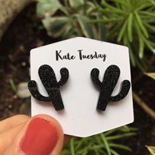 Black cactus-shaped acrylic earrings with sparkly accents by Olive Felix, featuring a trendy, playful jewelry design.