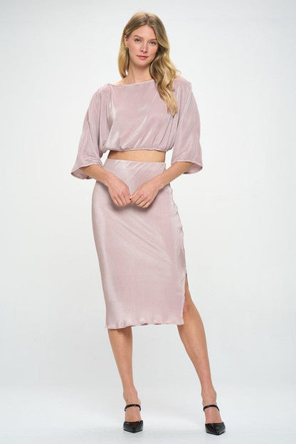 Jade Icarus Made in USA solid plisse midi skirt with front slit, displayed on a hanger against a neutral background.