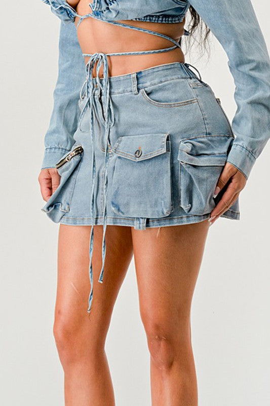 Jade Icarus Denim Daze wrap skirt in denim fabric, displayed on a hanger with a neutral background.