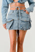 Jade Icarus Denim Daze Wrap Skirt in denim fabric with a stylish wrap design, shown on a mannequin.