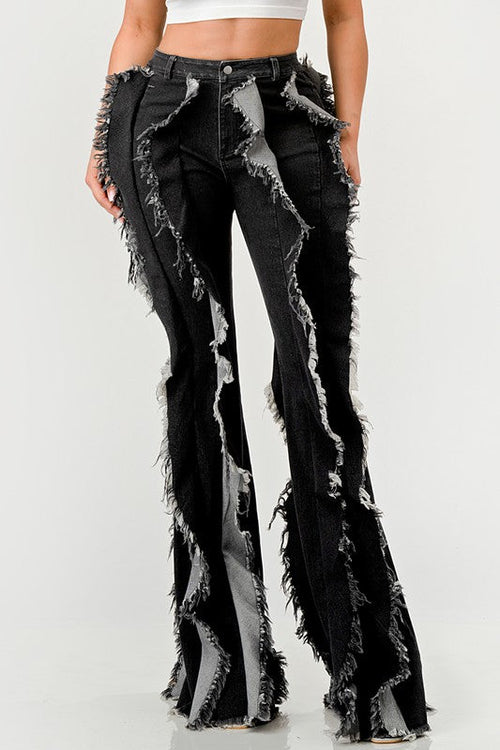 Distressed denim frill jeans by Jade Icarus featuring ruffled details and a trendy, worn-in look.