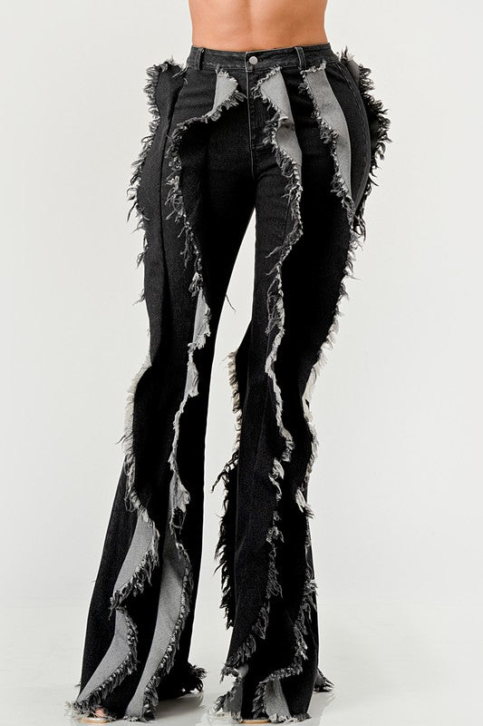 Distressed denim frill jeans by Jade Icarus featuring ruffled details and a casual, worn-in look.