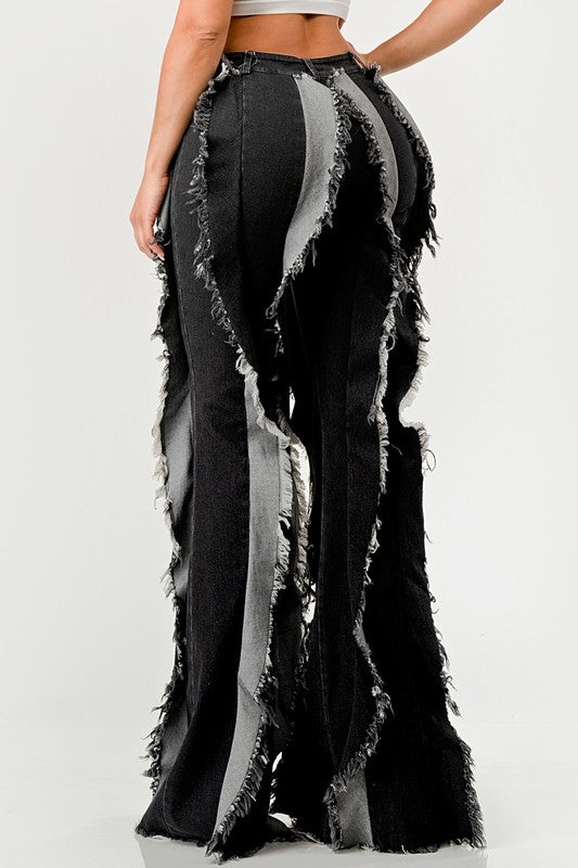 Distressed denim frill jeans by Jade Icarus, featuring ripped details and decorative frills on a pair of stylish jeans.