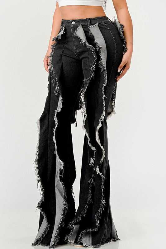 Distressed denim frill jeans by Jade Icarus featuring ripped details and frilled hems on light blue denim.