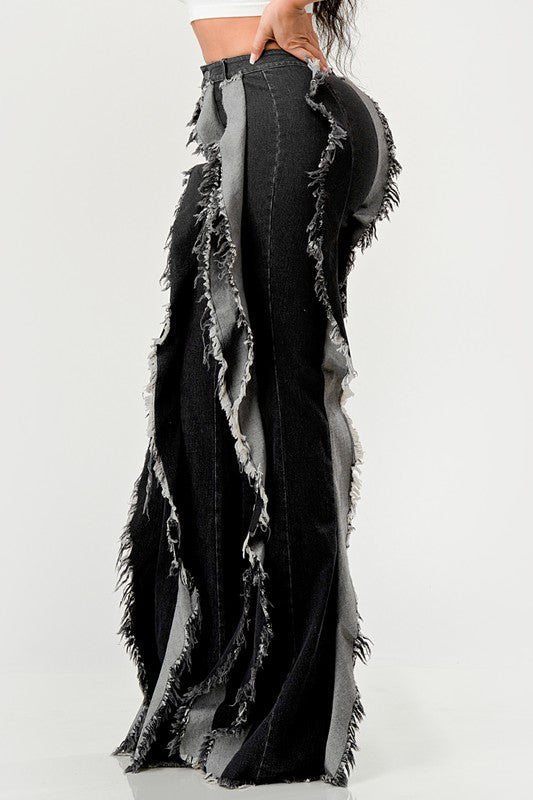 Distressed denim frill jeans by Jade Icarus featuring ripped details and a frilled hem, displayed on a model.