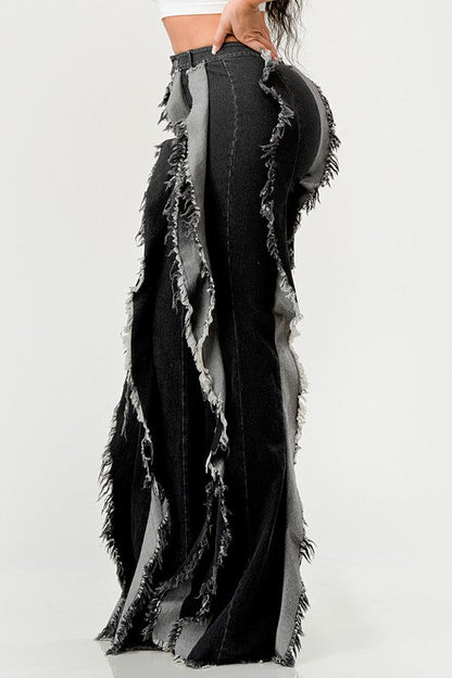 Distressed denim frill jeans by Jade Icarus featuring ripped details and a frilled hem, displayed on a model.