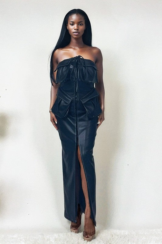 Black leather dress with button details by Jade Icarus, featuring a sleek, fitted design and subtle stitching accents.